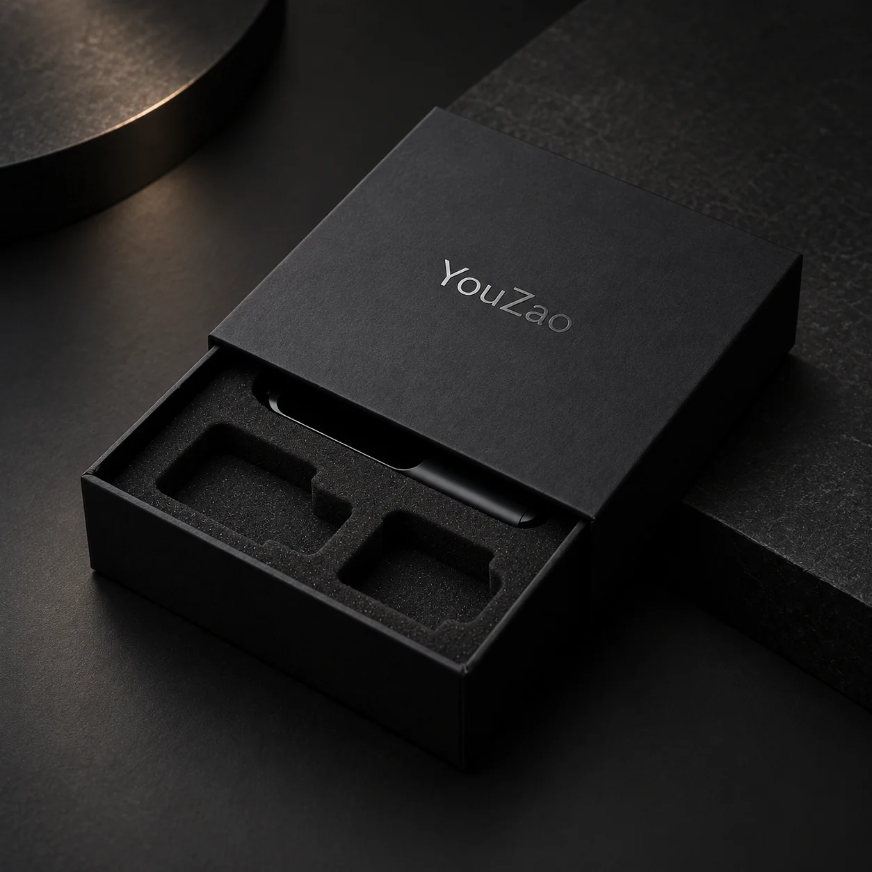 Black rigid cardboard drawer box with a shaped foam insert for an electronics presentation