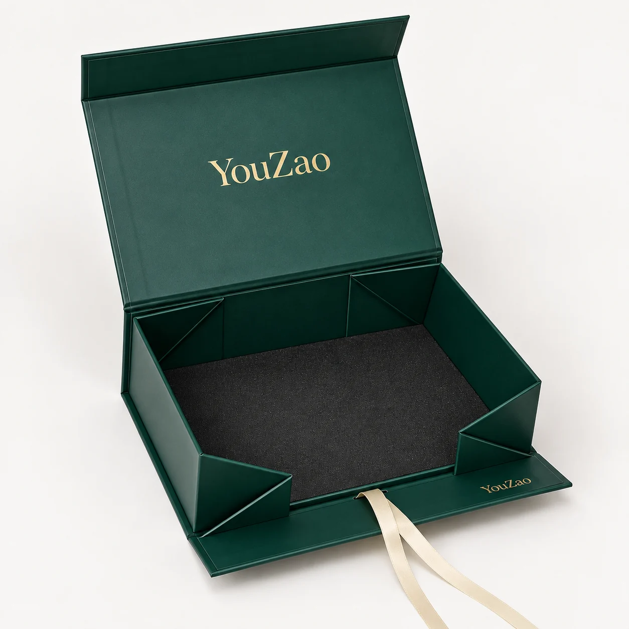 Open green collapsible magnetic gift box showing folding corners and satin ribbon