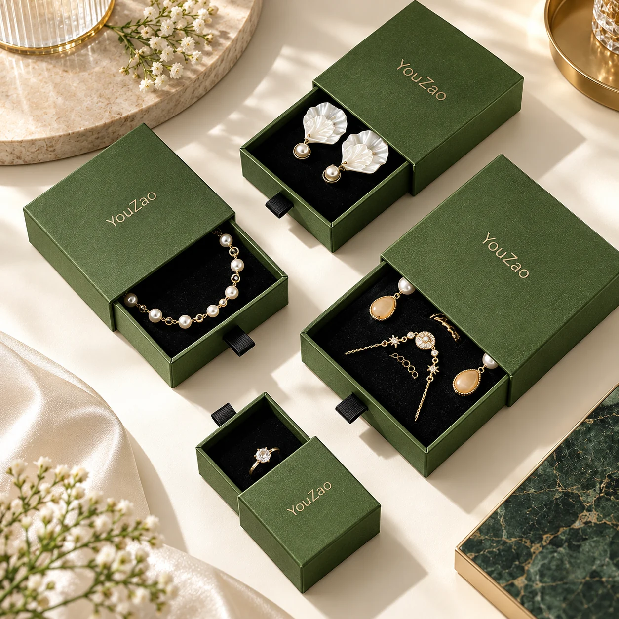 Green jewelry drawer boxes illustrating alternative gift presentation and ribbon pulls