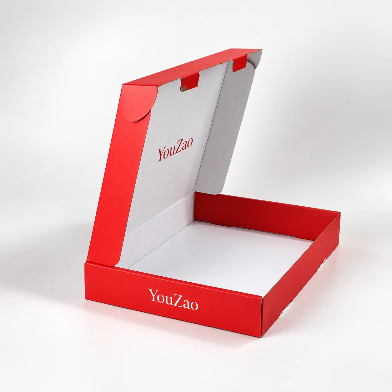 Open red shallow folding mailer box showing attached lid and white interior