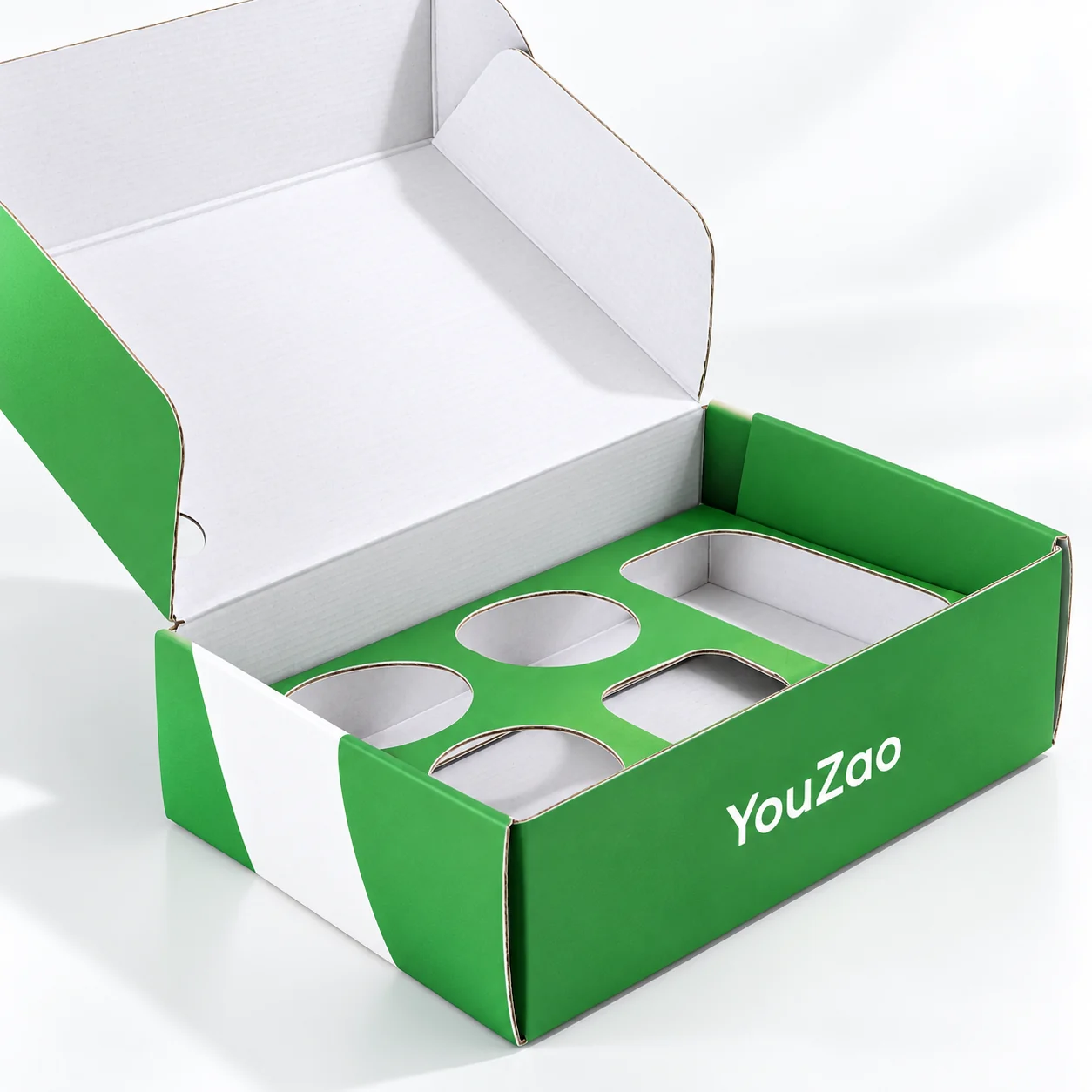 Open green corrugated folding mailer gift box with circular and rectangular insert openings
