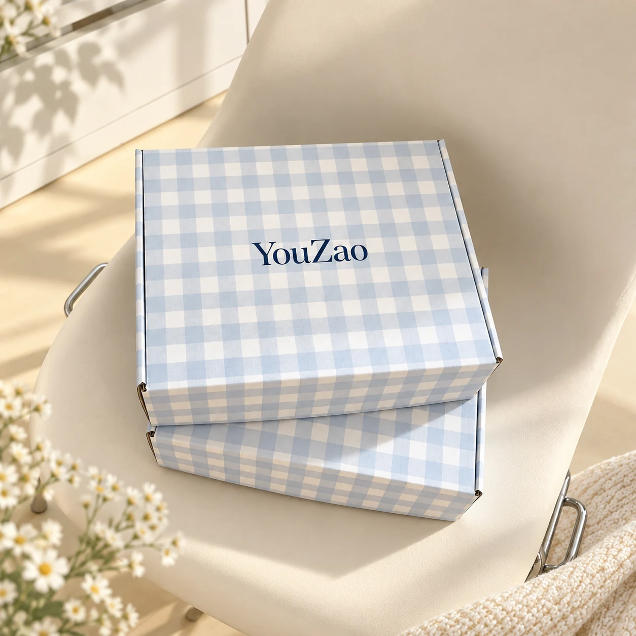 Blue and white plaid YouZao packaging box shown closed in sunlight