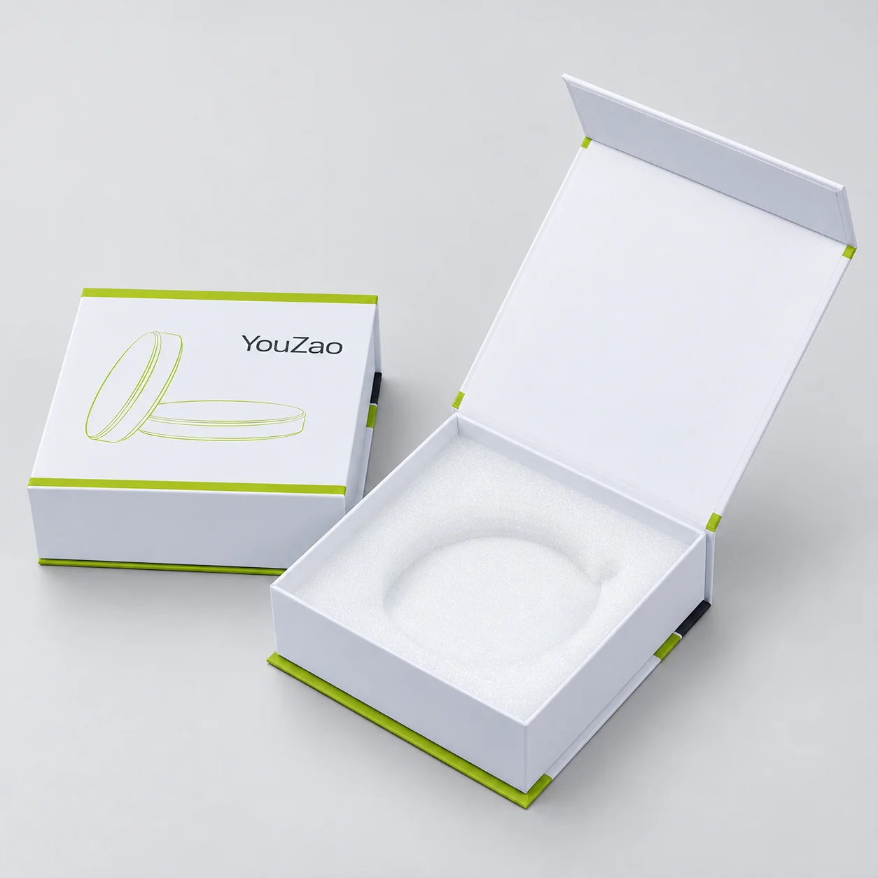 Open white magnetic-lid box with a circular recess insert beside a closed box