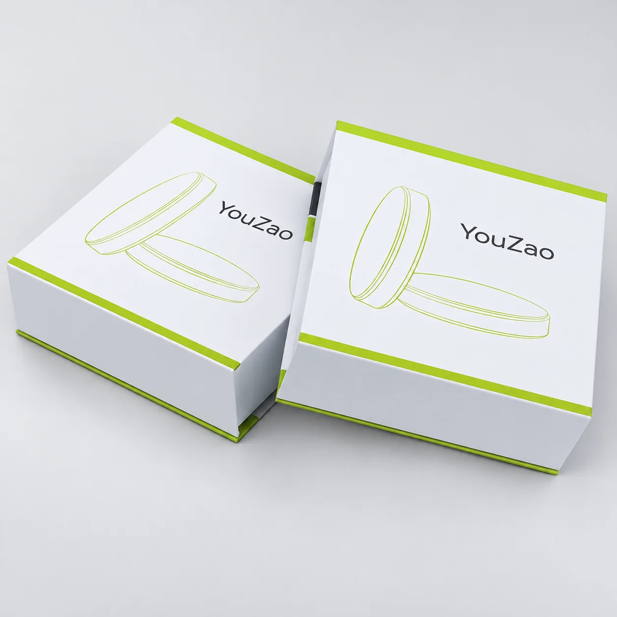 Two closed white electronics presentation boxes with lime-green trim and printed artwork